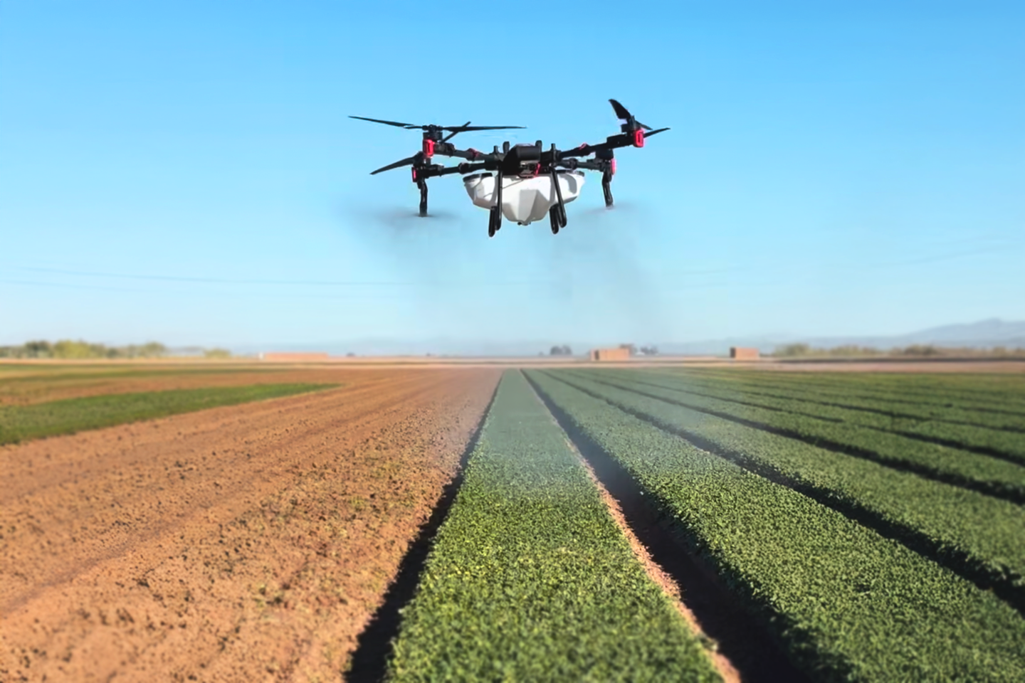 An XAG P100 spray drone crop dusting a field in Arizona