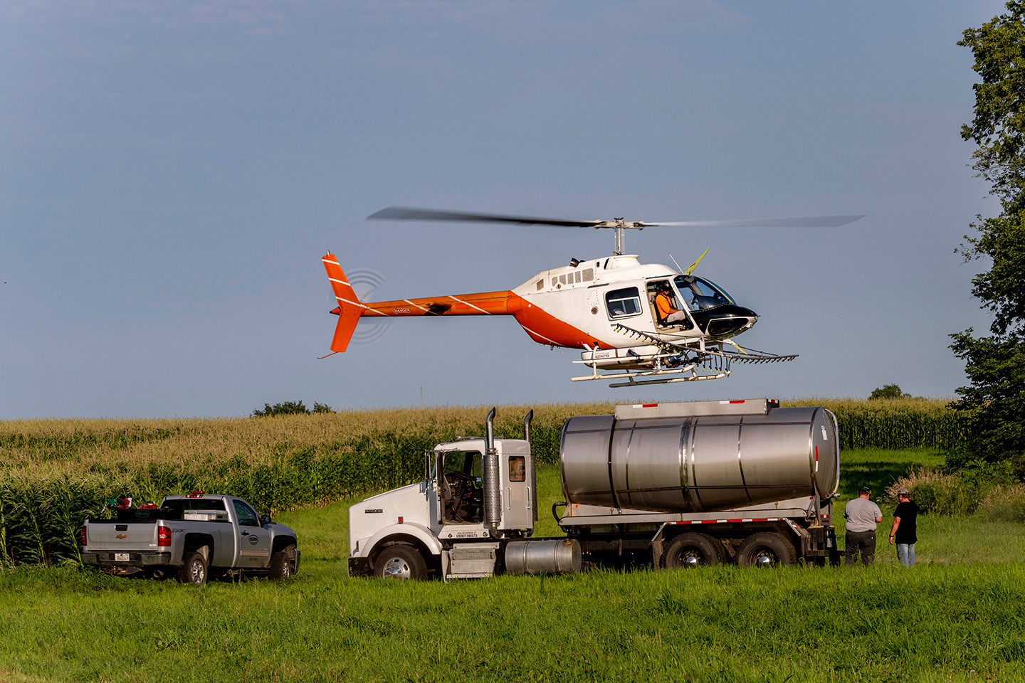 Spray helicopter landing on a truck